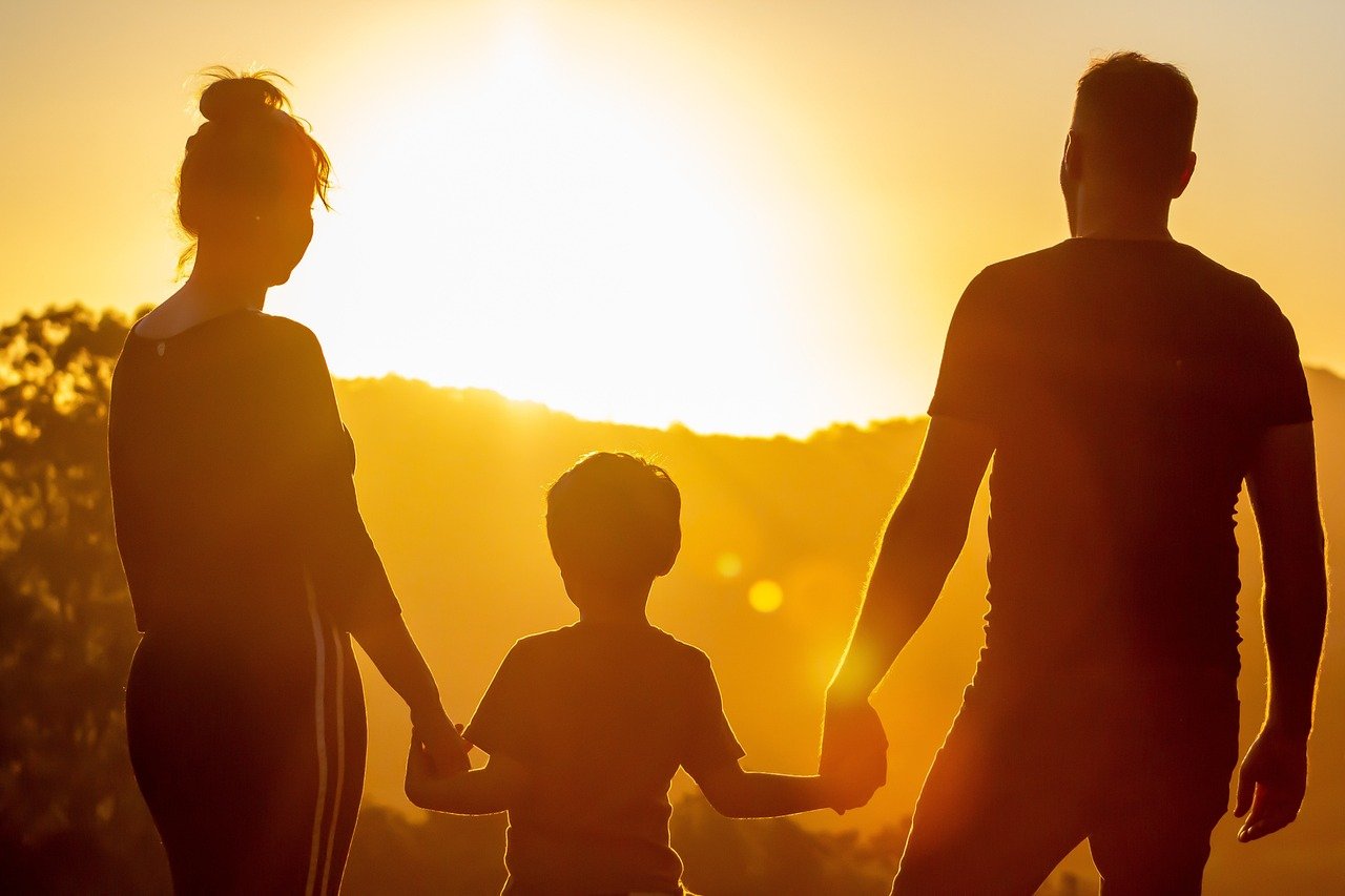 A family walking and watching sunset together