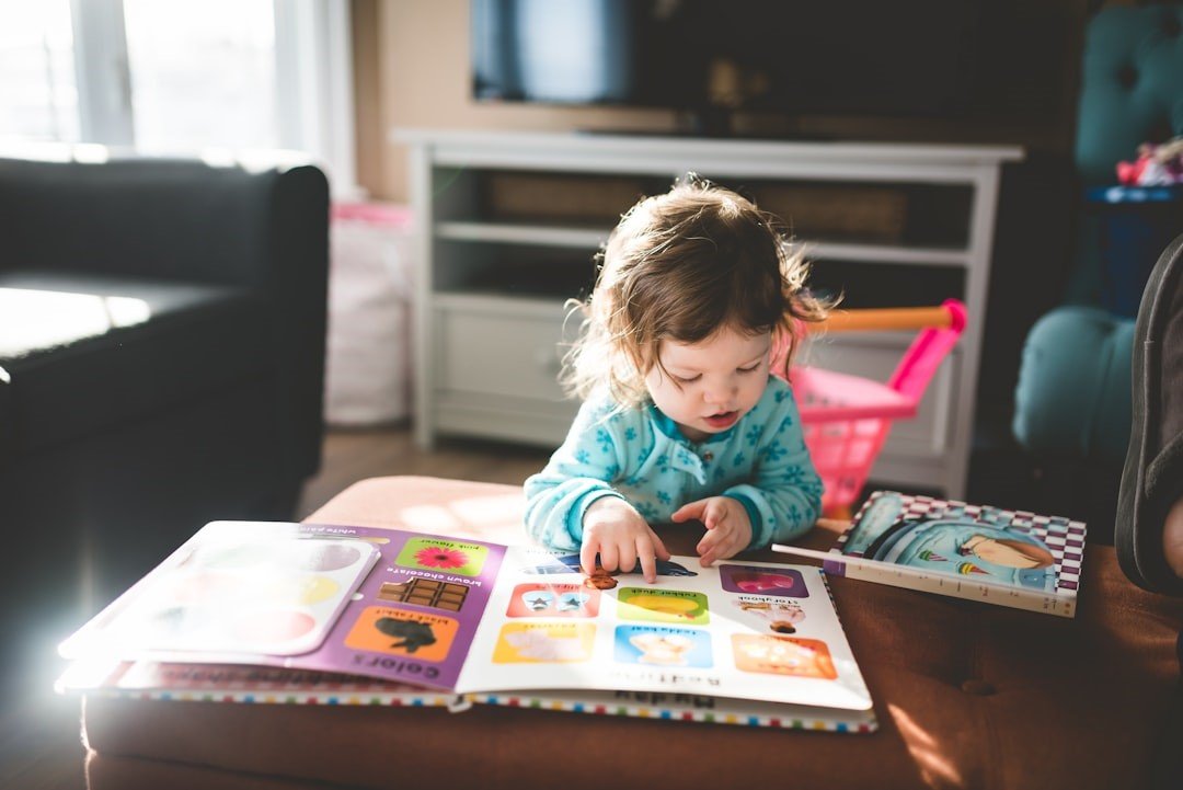 A little girl reading picture books