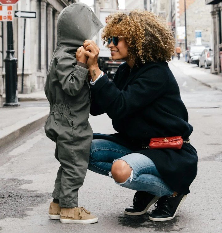 A woman is making eye contact with her child and talk