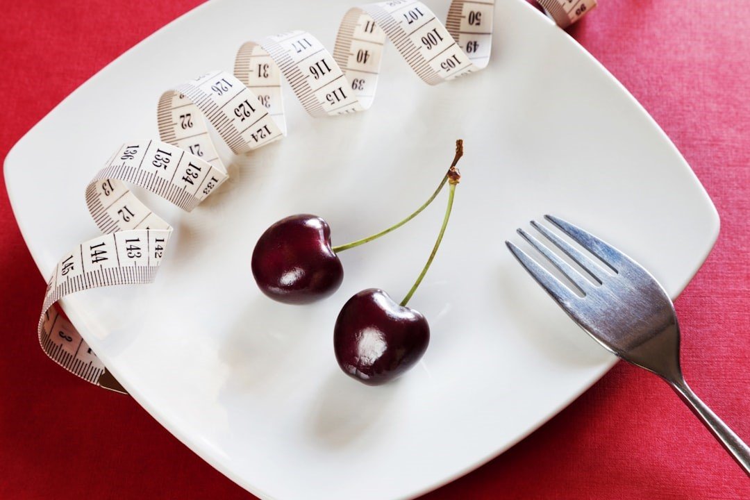 Only a pair of cherries and measuring tape on the plate