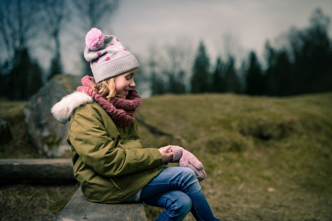 A girl sitting on stone bench in forest