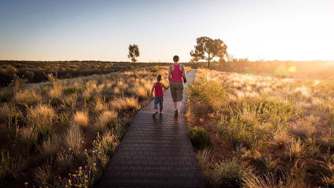 Mom and child walking on a field