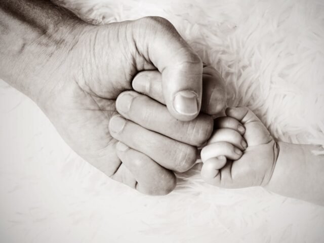 child and father fist touch